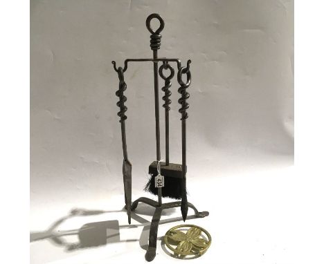A metal fireplace companion set, including poker, shovel and brush with stand, together with a brass fork and stand