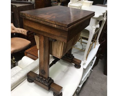 A William IV rosewood work table, swivel fold over top, over drawer and pleated satin pull out well, on trestle and block sup