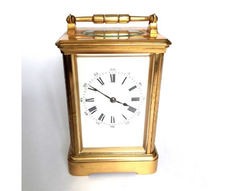 A French gilt brass striking carriage clock, white dial with Roman numerals, carrying handle, 14cm high
