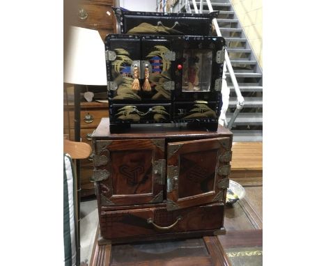 A Chinese style table-top cabinet, fitted two doors revealing six drawer interior, together with a Japanese black lacquered c