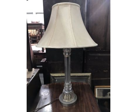 A glass table lamp base, lobed reeded form, on facet sickle foot and circular metal base 