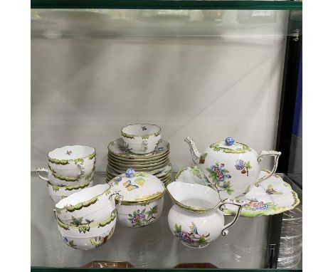 A Herend part tea service, hand painted with peony and butterfly design, with riven rattan moulded borders including teapot, 