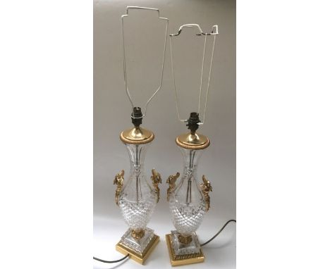 A pair of cut glass lamp bases, baluster form with gilt metal swan handles, on square gilt metal base, 53cm high, including f