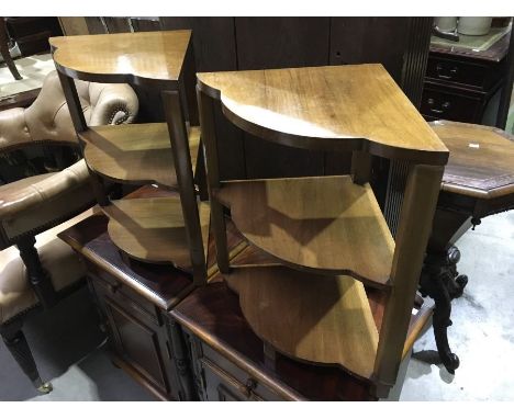 A pair of Art Deco walnut veneered three shelf side tables on block supports. 50cm high. (2) 