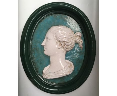 A pair of ceramic portrait plaques in the classical style, oval form,  turquoise ground and painted frames, 48cm overall heig