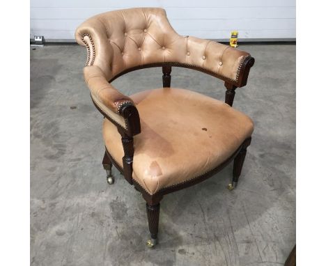 A William IV stained mahogany Captains chair, nude leather buttoned back upholstery, stuff-over seat; on turned wrythen carve