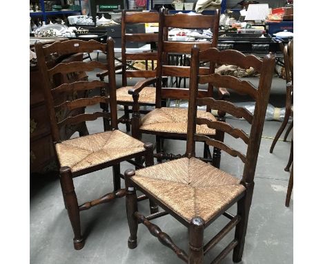 A pair of rush seated country oak ladder back armchairs, together with two similar single chairs (4) 