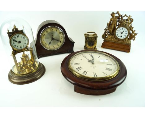 An 11 inch high brass torsion clock under a glass dome, a twelve inch diameter wall clock with cast brass bezel and mahogany 