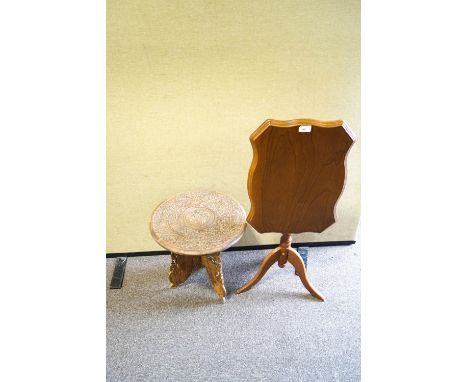 A tripod table together with a small carved table 