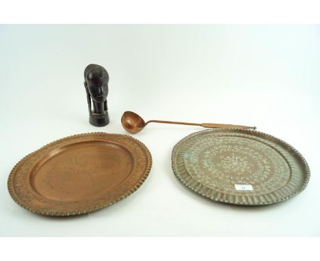 Two copper trays, a ladle and an African bust