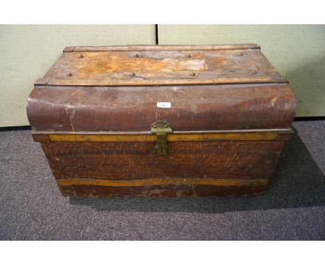An early 20th century tin dome top trunk with scumbled finish