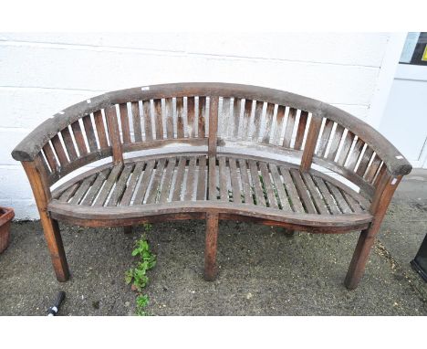 A carved teak garden bench