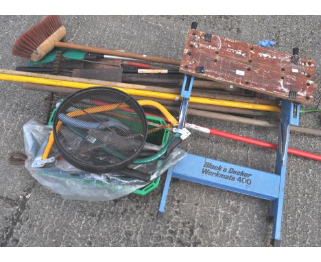 A collection of garden tools, to include a work bench, saws, brushes, fork and others