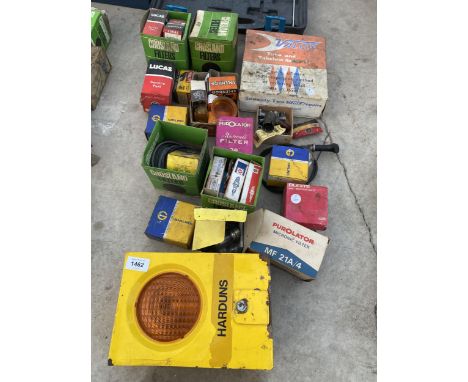 A LARGE ASSORTMENT OF VINTAGE AUTOMOBILE SPARES TO INCLUDE FILTERS, BULBS AND SPARK PLUGS ETC 