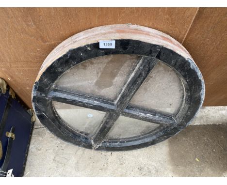 A VINTAGE WOODEN FRAMED ROUND WINDOW 