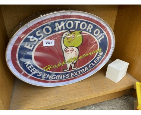 AN ILLUMINATED OVAL 'ESSO MOTOR OIL' SIGN WITH PLUG AND LEAD 