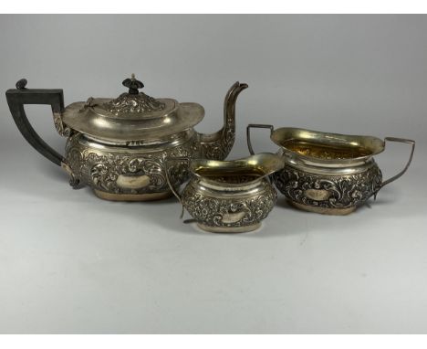 AN EDWARDIAN SILVER THREE PIECE TEA SET COMPRISING TEAPOT, SUGAR BOWL AND CREAM JUG, HALLMARKS FOR BIRMINGHAM, 1902, MAKERS A