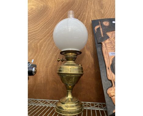 A VINTAGE BRASS OIL LAMP WITH GLASS FUNNEL AND WHITE GLASS SHADE 