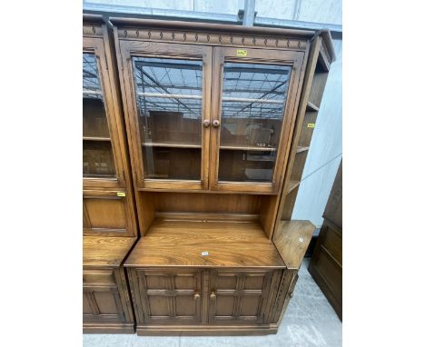AN ERCOL ELM DRESSER WITH GLAZED UPPER PORTION AND DRAWERS AND CUPBOARDS TO THE BASE, 38" WIDE 