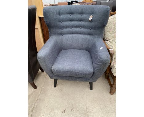 A MODERN WINGED BUTTON-BACK EASY CHAIR ON BLACK TAPERING KICK-OUT LEGS 