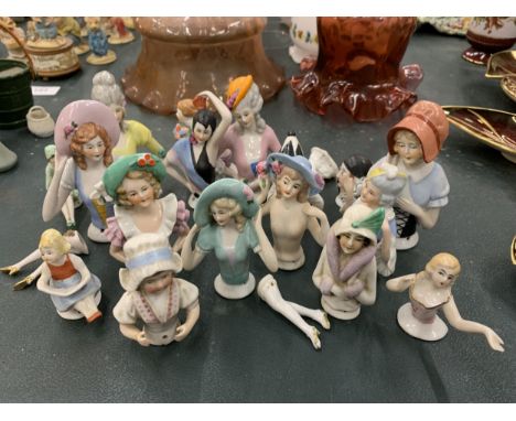 A COLLECTION OF CERAMIC SEWING/PIN CUSHION LADIES 