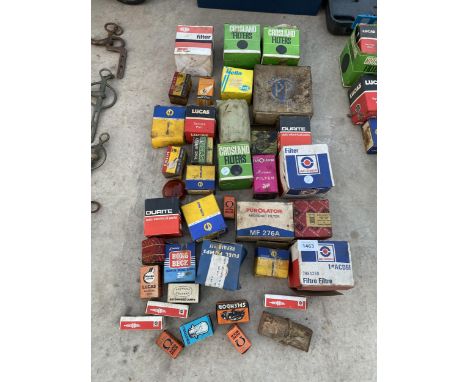 A LARGE ASSORTMENT OF VINTAGE AUTOMOBILE SPARES TO INCLUDE FILTERS AND BULBS ETC 
