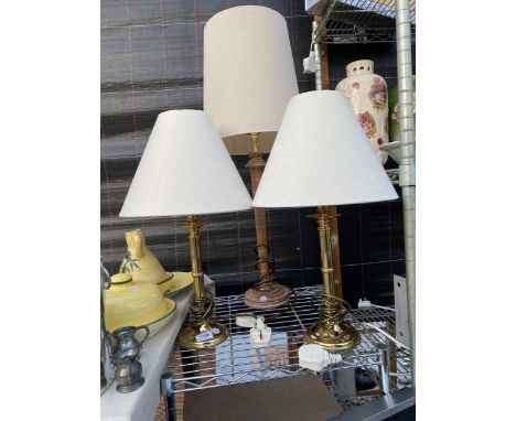 A PAIR OF BRASS TABLE LAMPS AND A FURTHER WOODEN TABLE LAMP ALL COMPLETE WITH SHADES 