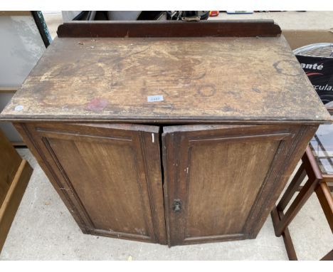 AN EDWARDIAN MAHOGANY TWO DOOR CABINET, 30" WIDE 