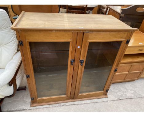 A MODERN BEECH TWO DOOR GLAZED CABINET 