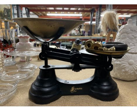A SET OF CAST SCALES WITH BRASS PAN AND WEIGHTS 
