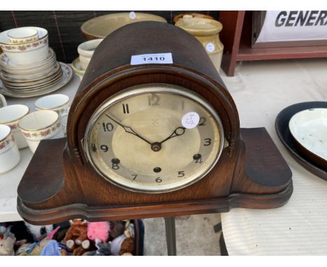 A WOODEN CASED WESTMINISTER CHIMING CLOCK WITH KEY 
