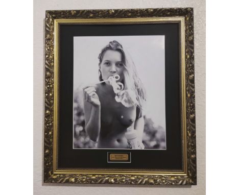 Photographer Bruce Weber photograph of model Kate Moss. Kate Moss blowing bubbles seductively on Golden beach, Florida, 1997.