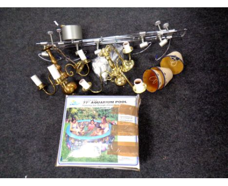An adjustable ceiling light rack together with two brass ceiling lights and an Aquarium pool.