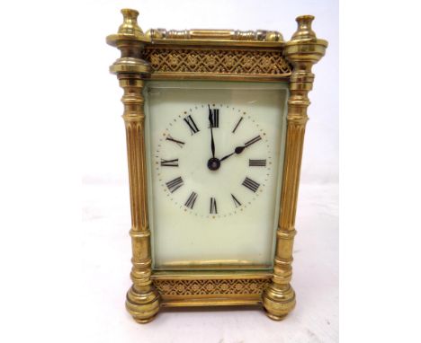A decorative brass-cased French carriage clock with key.