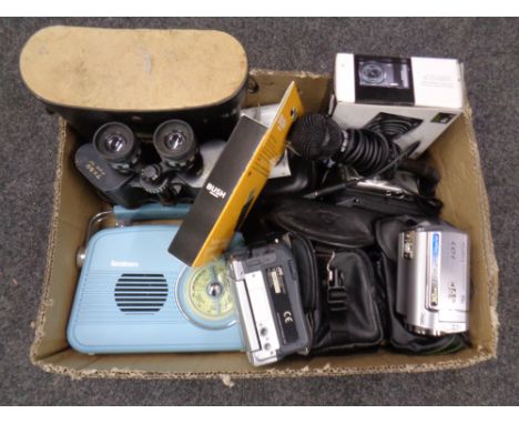 A box containing assorted digital and video cameras by Samsung and JVC, Goodmans retro style radio, Microphone, Panorama 7x50