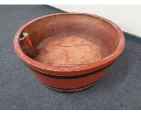 A large circular fibreglass planter in the form of a barrel.