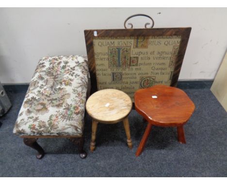A contemporary tapestry fire screen together with and adjustable stool and two milking stools.