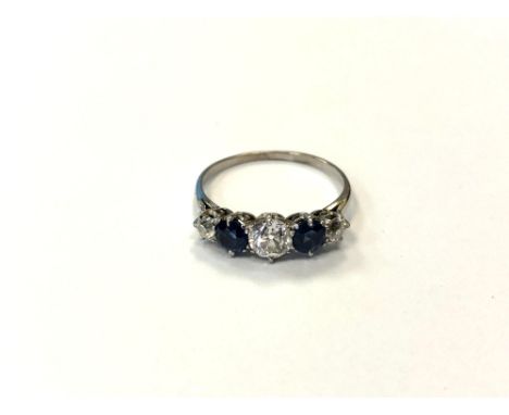 An early 20th century three stone diamond and sapphire ring, 1.9g, ring size N, 5.1 mm diameter central stone. CONDITION REPO