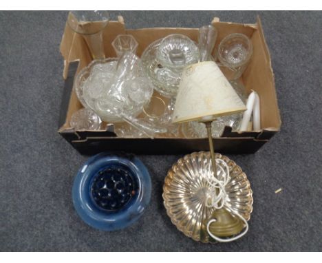 A box containing assorted glassware including blue glass bowl with flower holder, commemorative glasses, brass table lamp wit