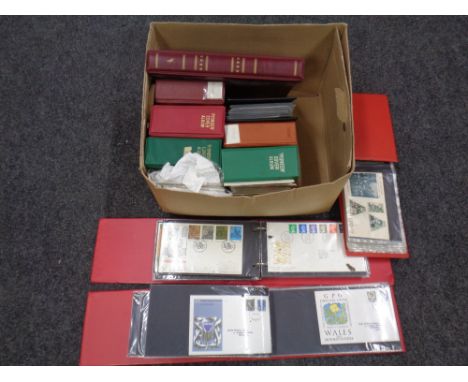 A box containing 11 albums of first day covers.