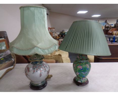 Two Chinese style floral ceramic table lamps on wooden bases with shades.