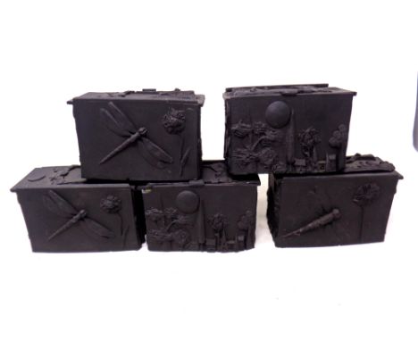 A set of five vintage black plastic embossed trinket boxes.