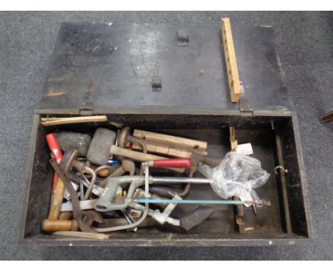 A pine tool box containing vintage hand tools 