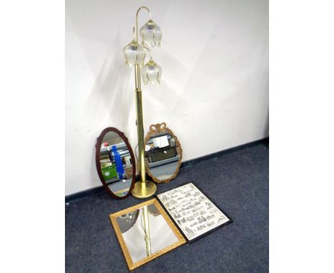 A brass three way floor lamp together with a framed print and three framed mirrors.