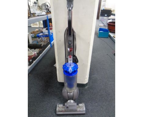 A Dyson DC41 upright ball vacuum with tools.
