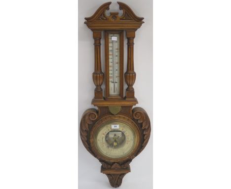 A Victorian carved oak thermometer/barmometer, 101cm high Condition Report: Available upon request