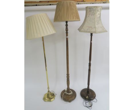 A modern brass standard lamp and two other standard lamps (3) Condition Report: Available upon request