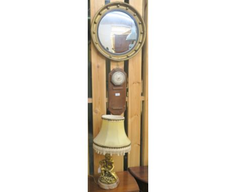 A gilt circular gilt wall mirror, a gilt cherub table lamp and a barometer (3) Condition Report: Available upon request