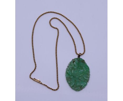 A Jade pendant and high ct gold chain