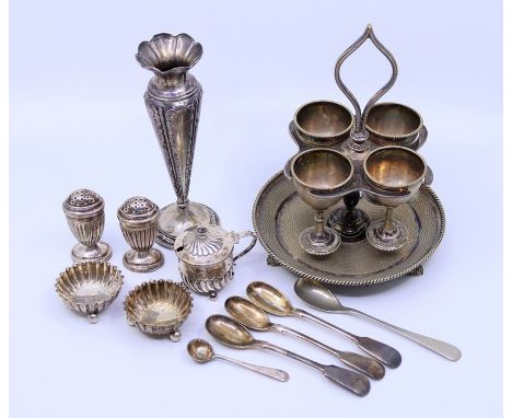 A silver small embossed tapered vase, silver semi-flunked mustard, pair of flunked pepperettes, a pair of salts, and a silver